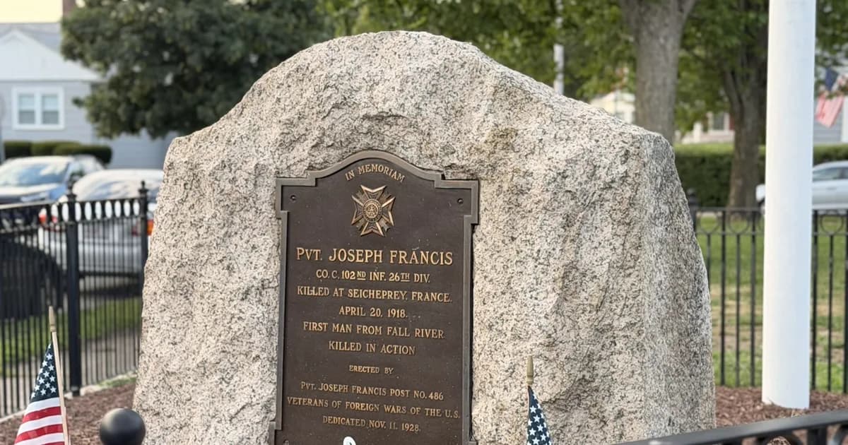 Granite memorial to Pvt. Joseph Francis, the first man from Fall River killed in action in World War I, flanked by American flags