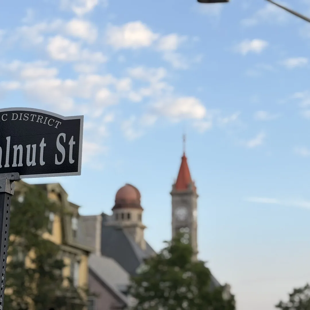 Historic District street sign for Walnut Street in Fall River with the Durfee clock tower in the distance