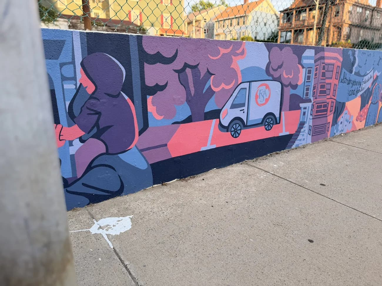 The mural along the Quequechan River Rail Trail — bold blues, pinks and reds.
