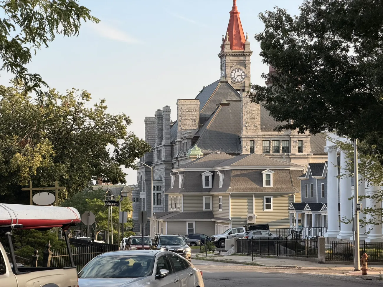 A Victorian clock tower rising above the rooftops of Fall River.
