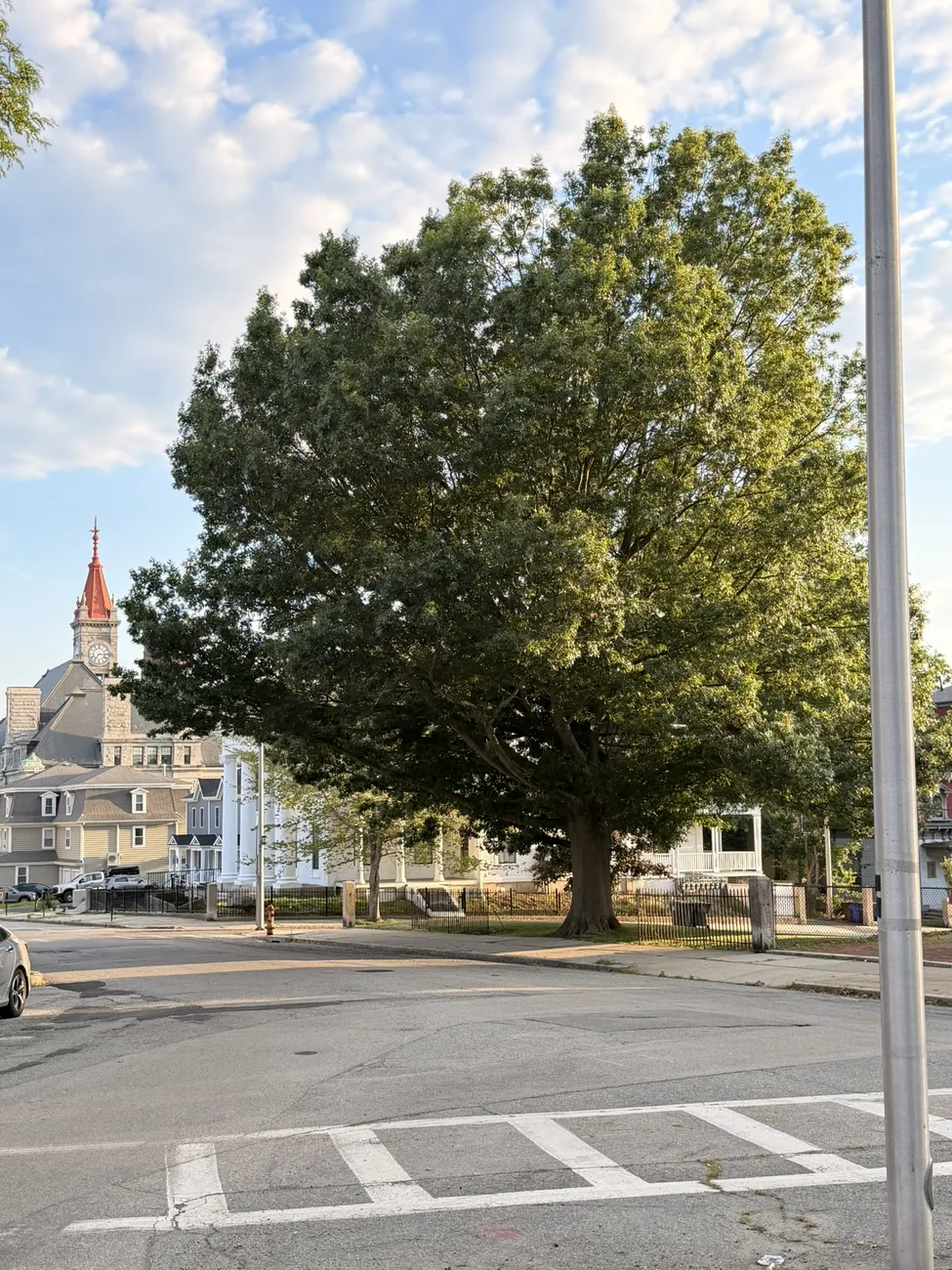 A Victorian clock tower rising above the rooftops of Fall River.