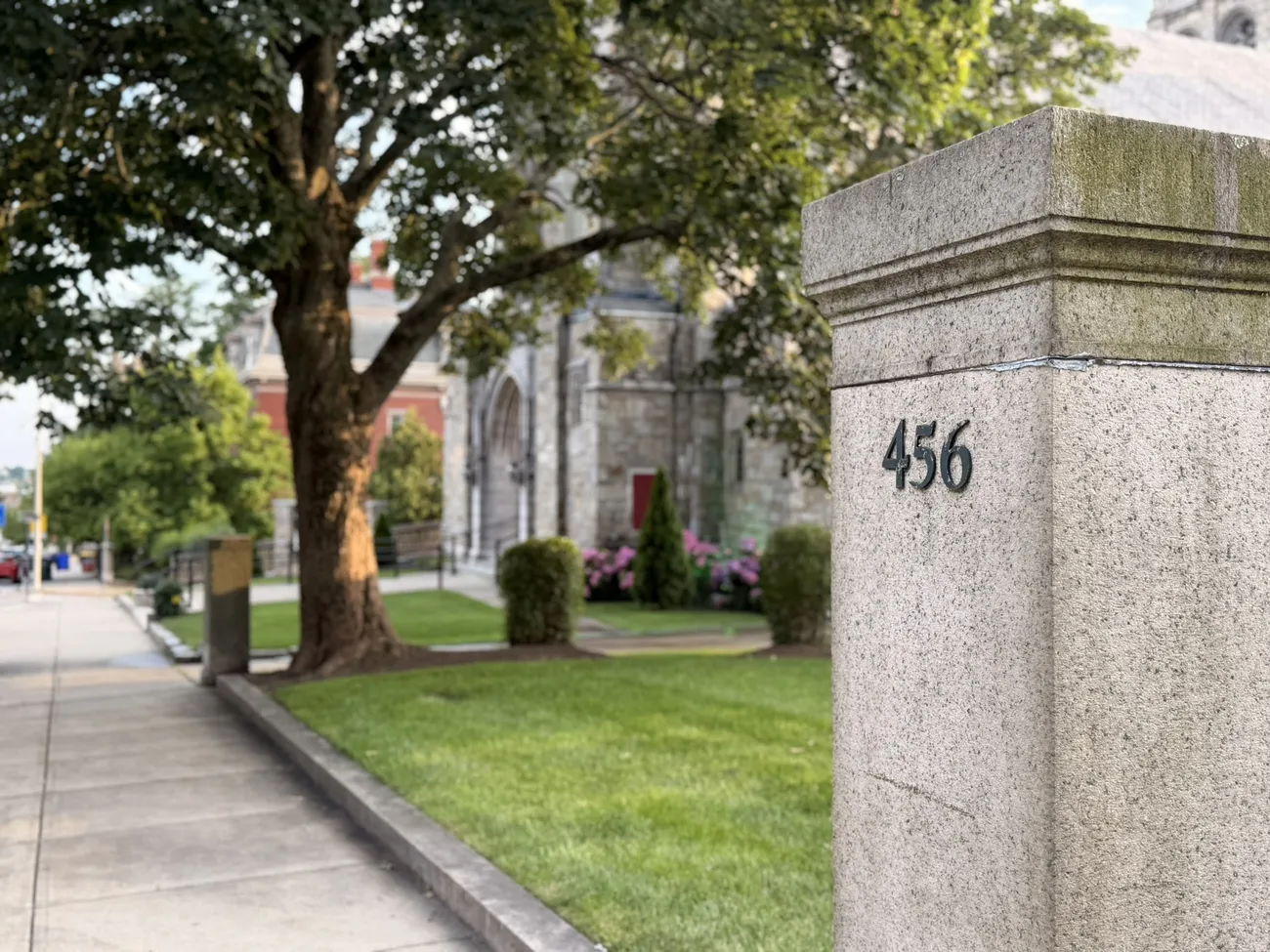Grand Victorian houses and stone gateposts along a tree-lined Fall River street.