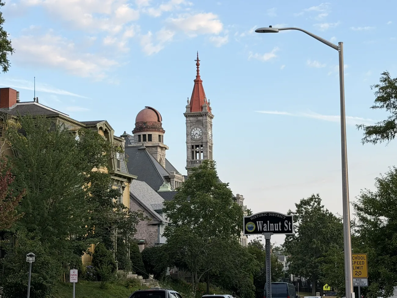 The Walnut Street sign, with a Victorian tower behind it.
