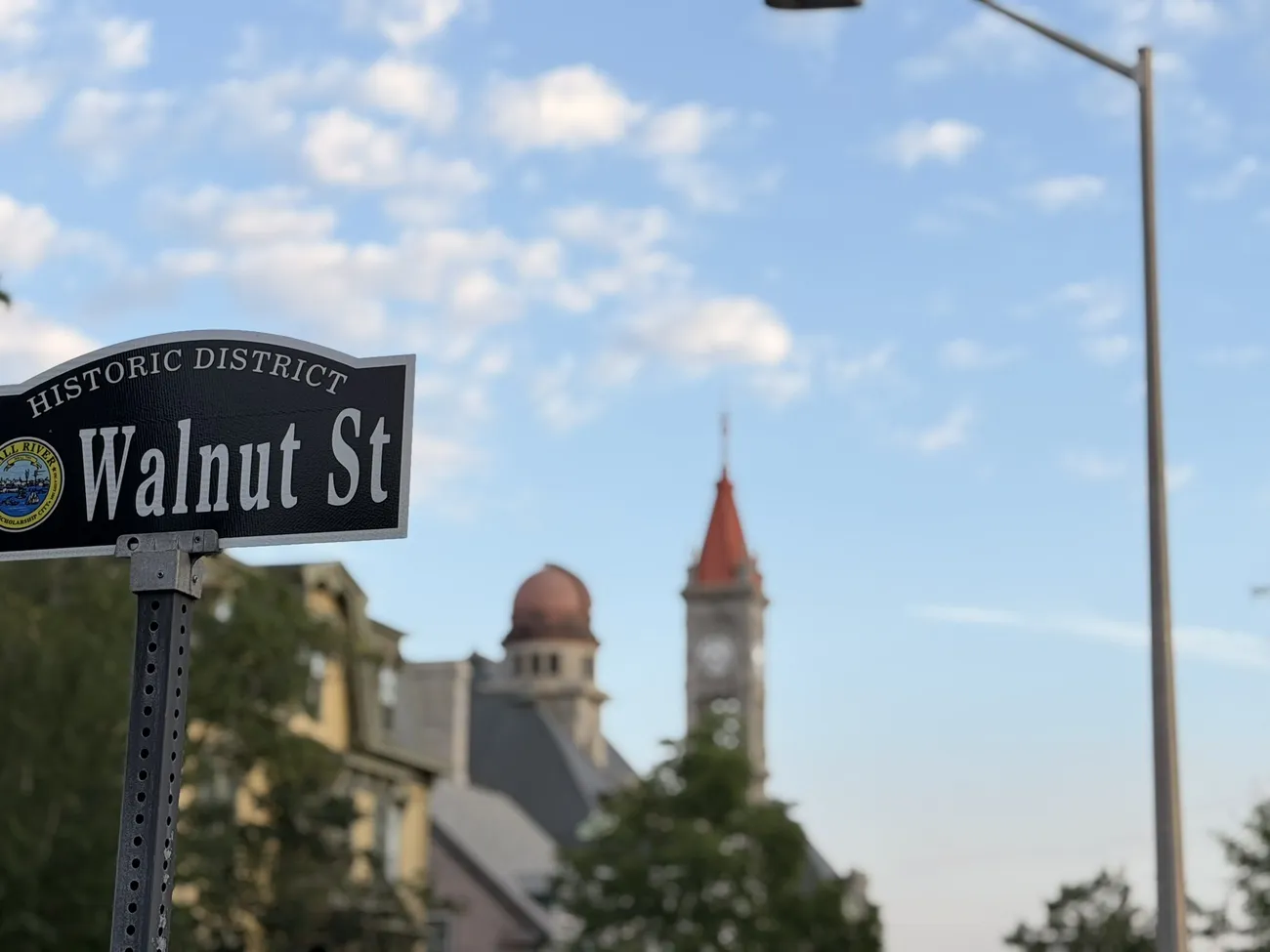 The Walnut Street sign, with a Victorian tower behind it.