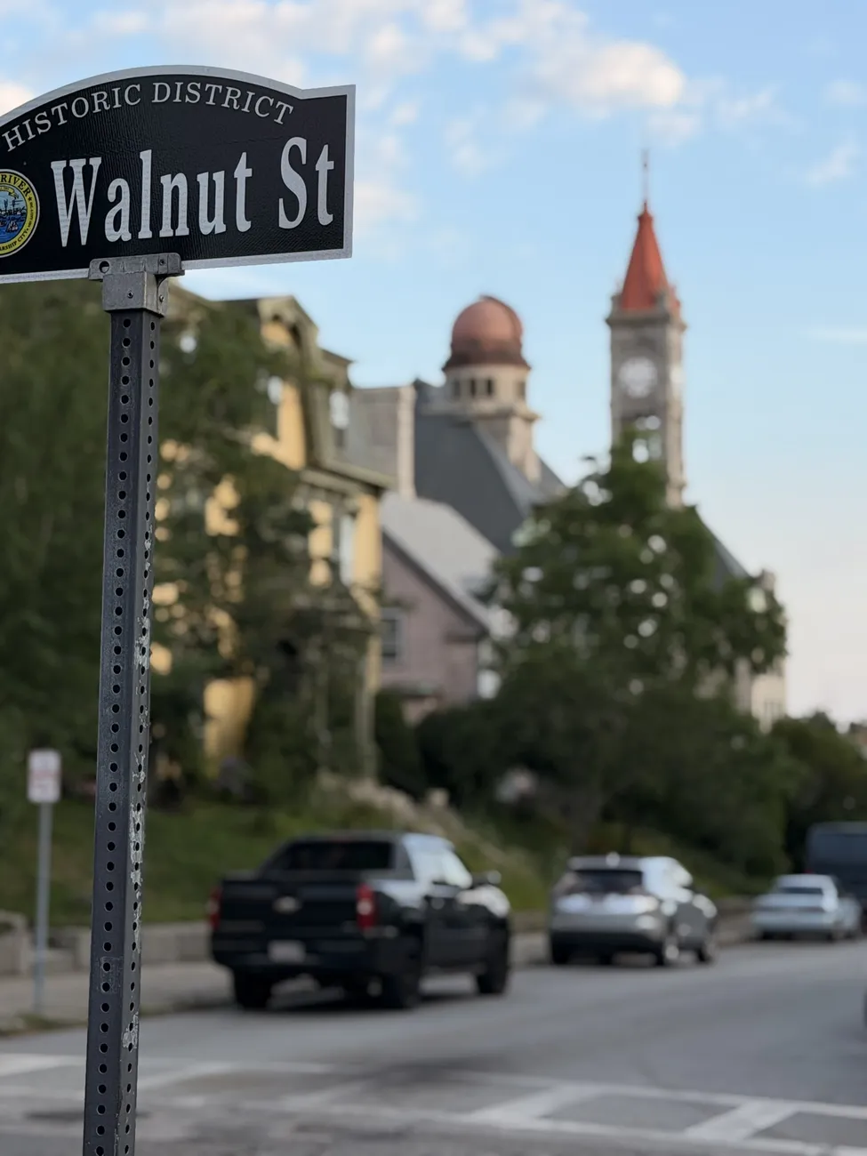 The Walnut Street sign, with a Victorian tower behind it.