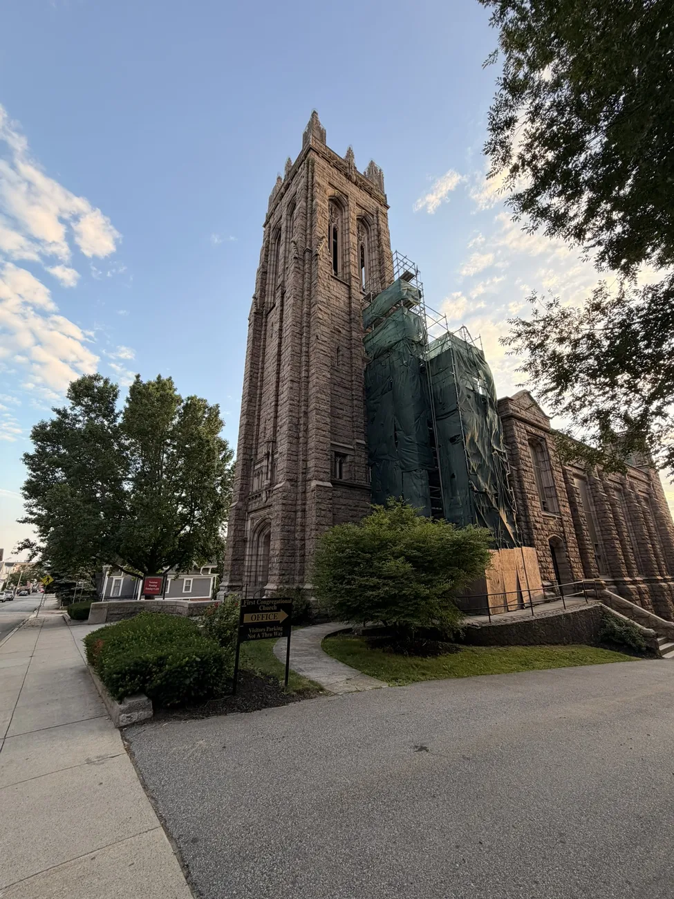A gothic stone church against a bright summer sky.