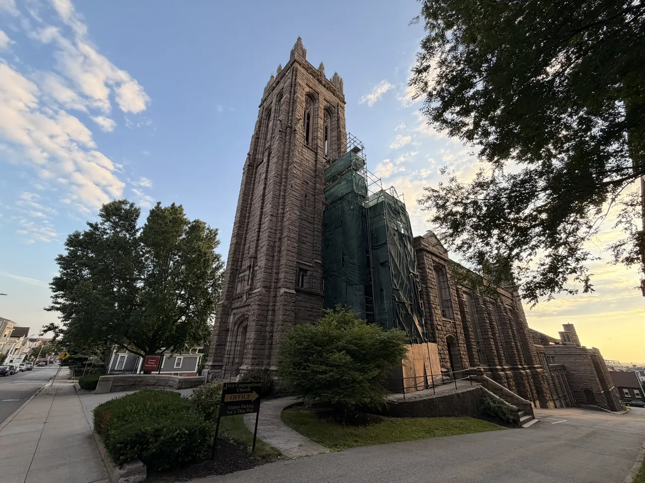 A gothic stone church against a bright summer sky.