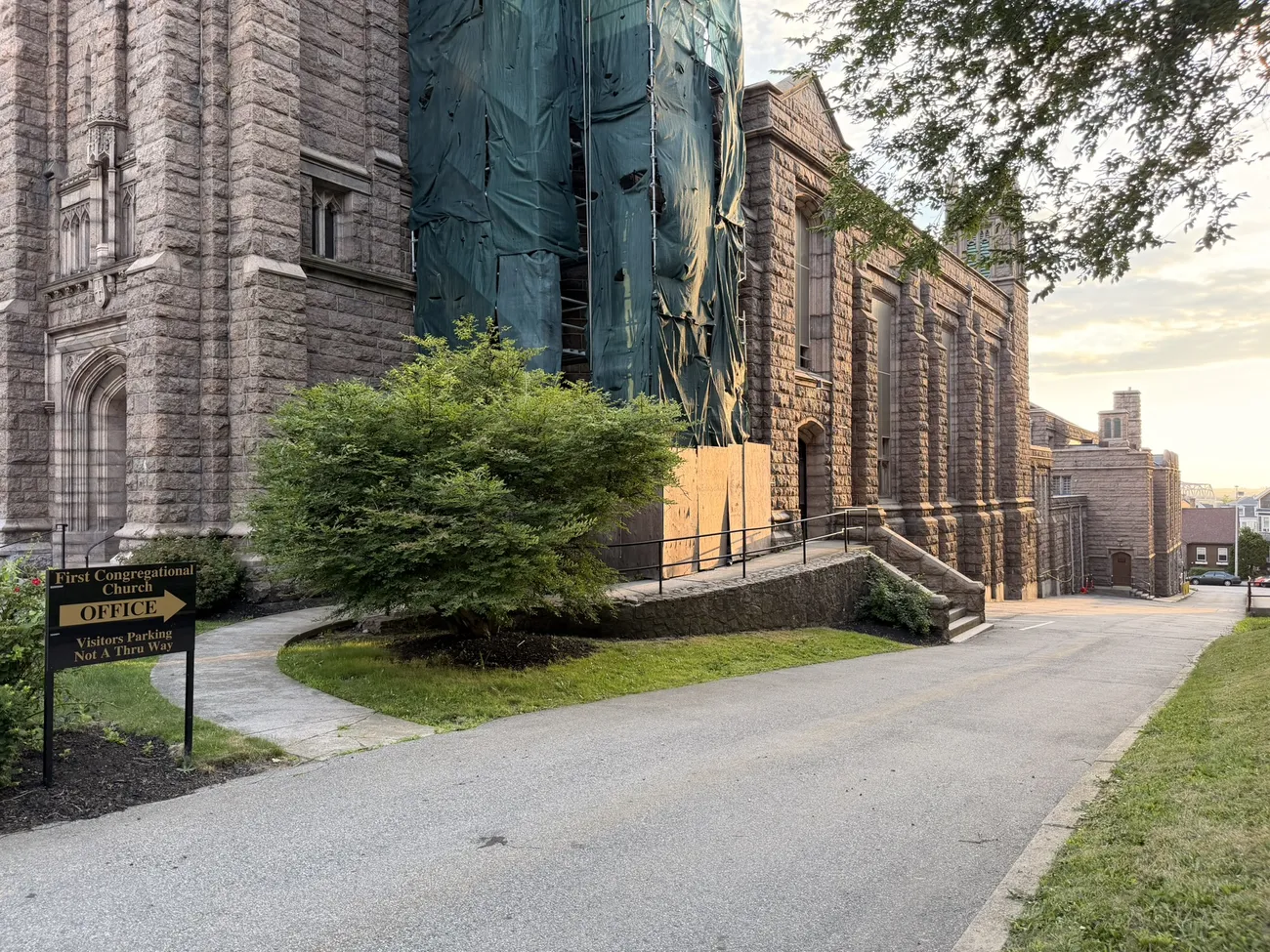 A gothic stone church against a bright summer sky.