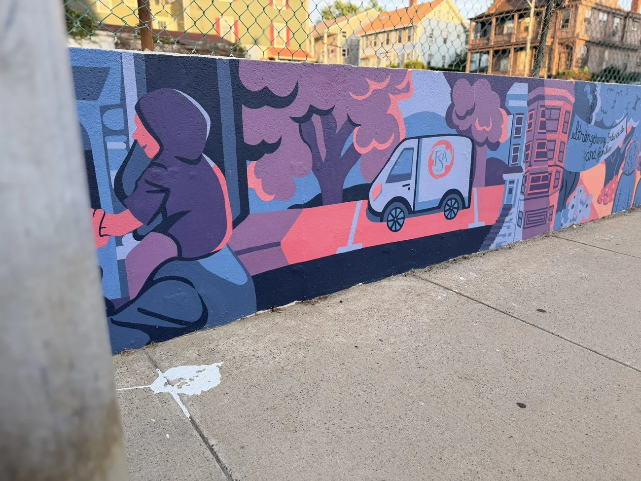 The mural along the Quequechan River Rail Trail — bold blues, pinks and reds.