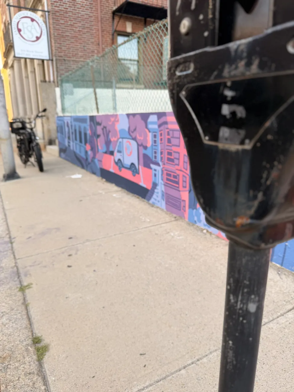 The mural along the Quequechan River Rail Trail — bold blues, pinks and reds.