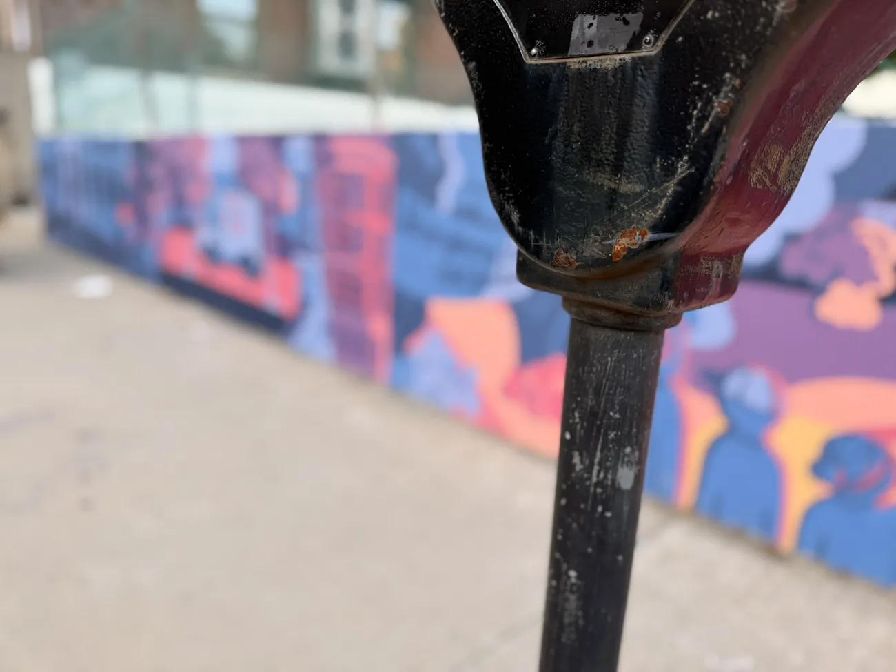 The mural along the Quequechan River Rail Trail — bold blues, pinks and reds.
