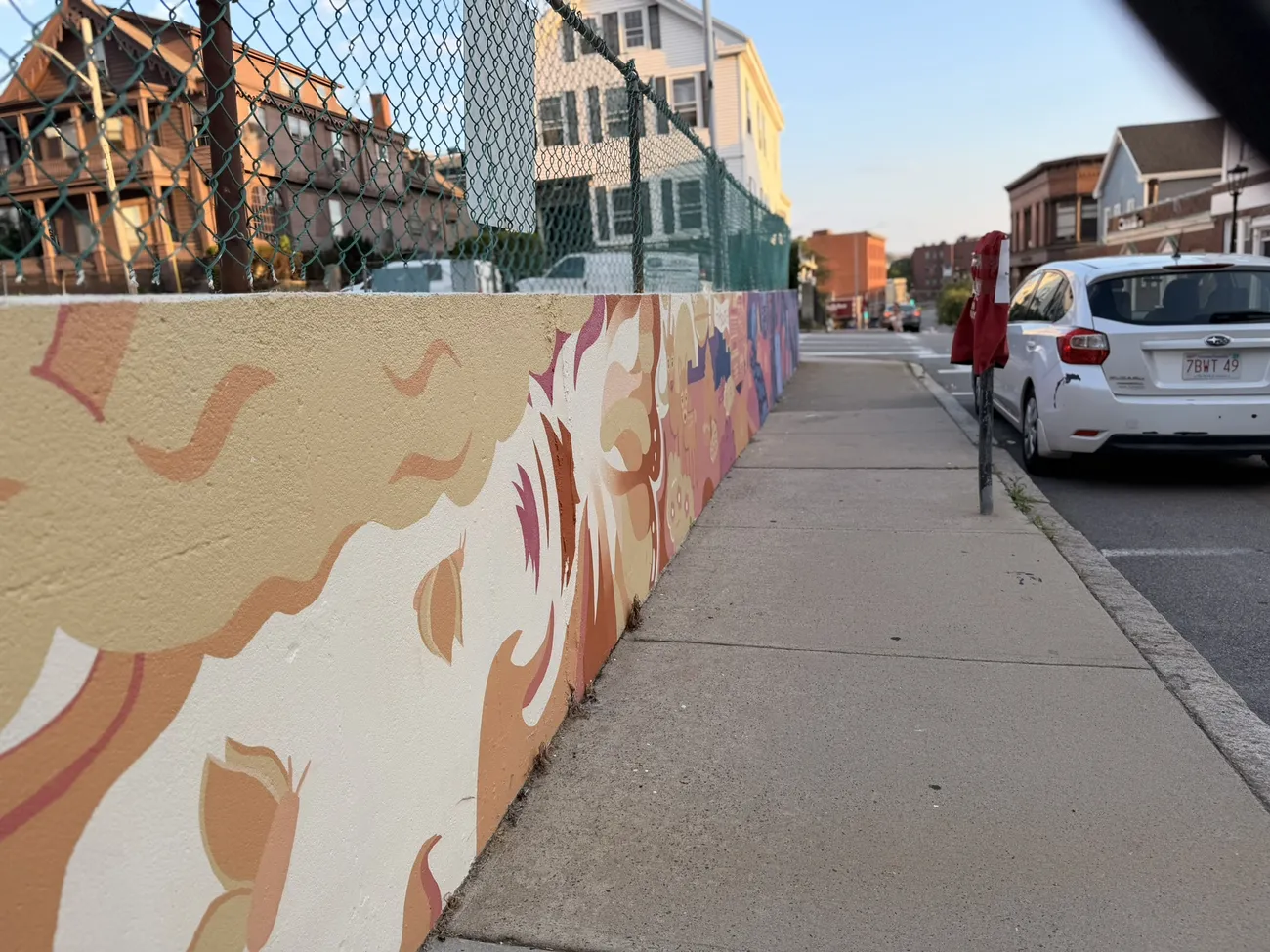 The mural along the Quequechan River Rail Trail — bold blues, pinks and reds.