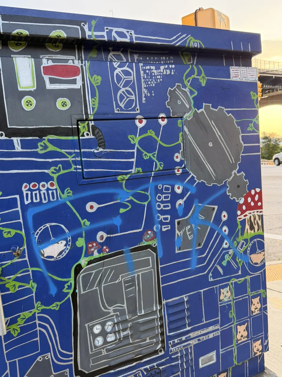 A utility box painted with circuit-board artwork — small-scale public art.