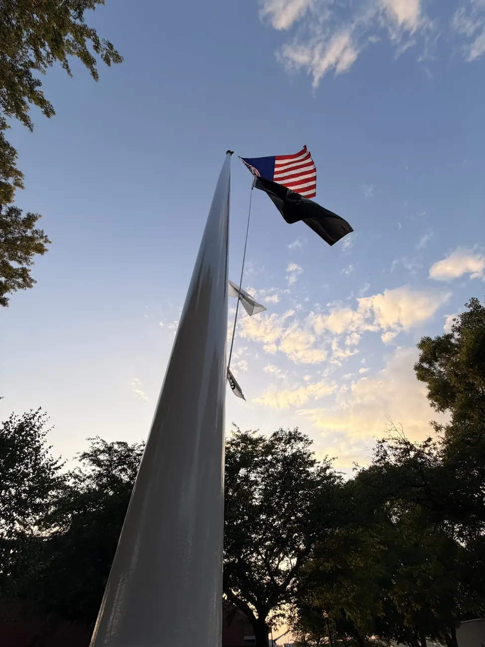 The white sails of the Fall River veterans memorial against an open sky.