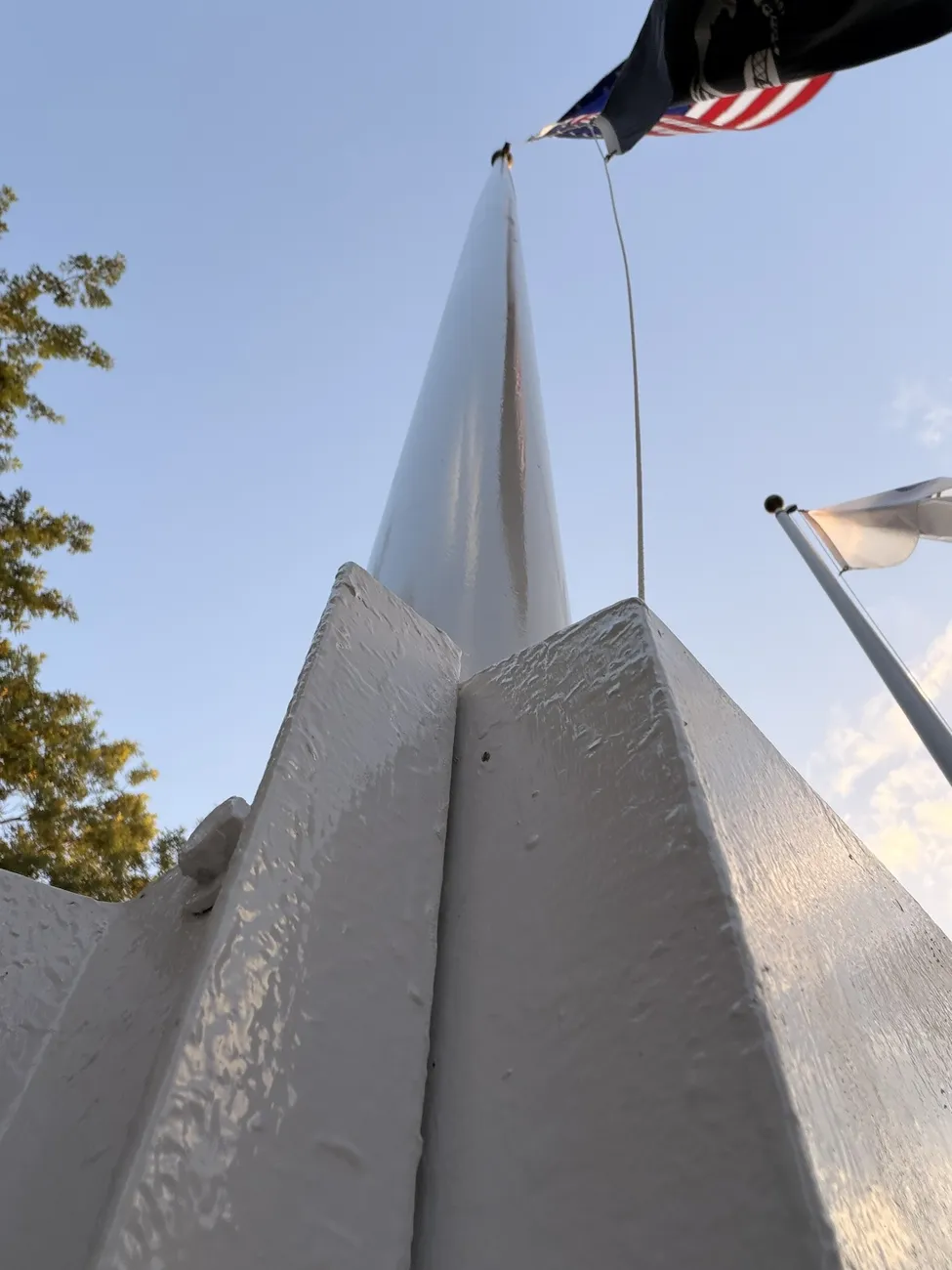 The white sails of the Fall River veterans memorial against an open sky.