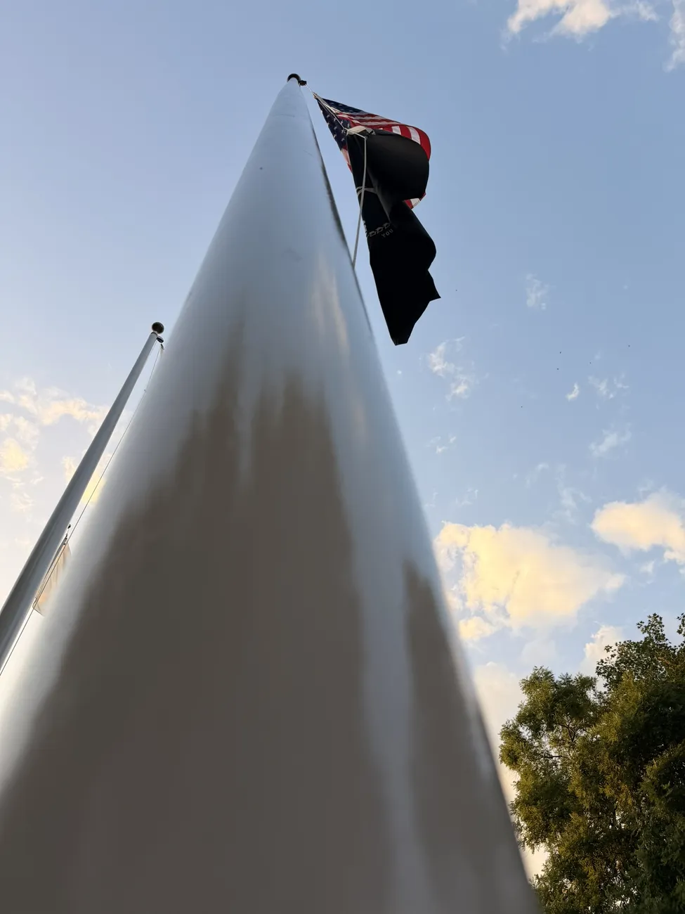 The white sails of the Fall River veterans memorial against an open sky.