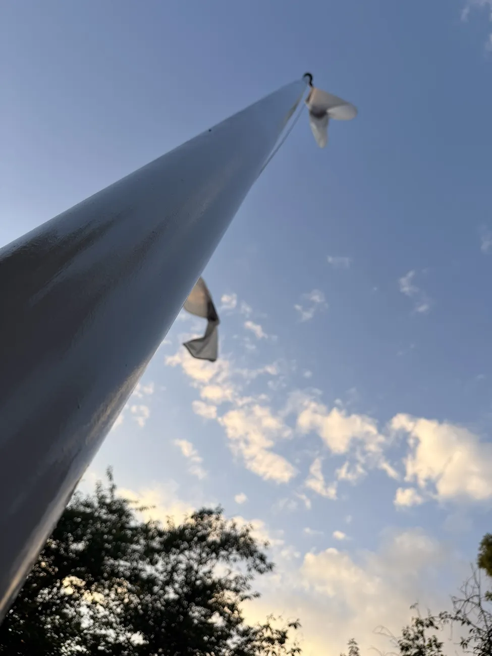 The white sails of the Fall River veterans memorial against an open sky.